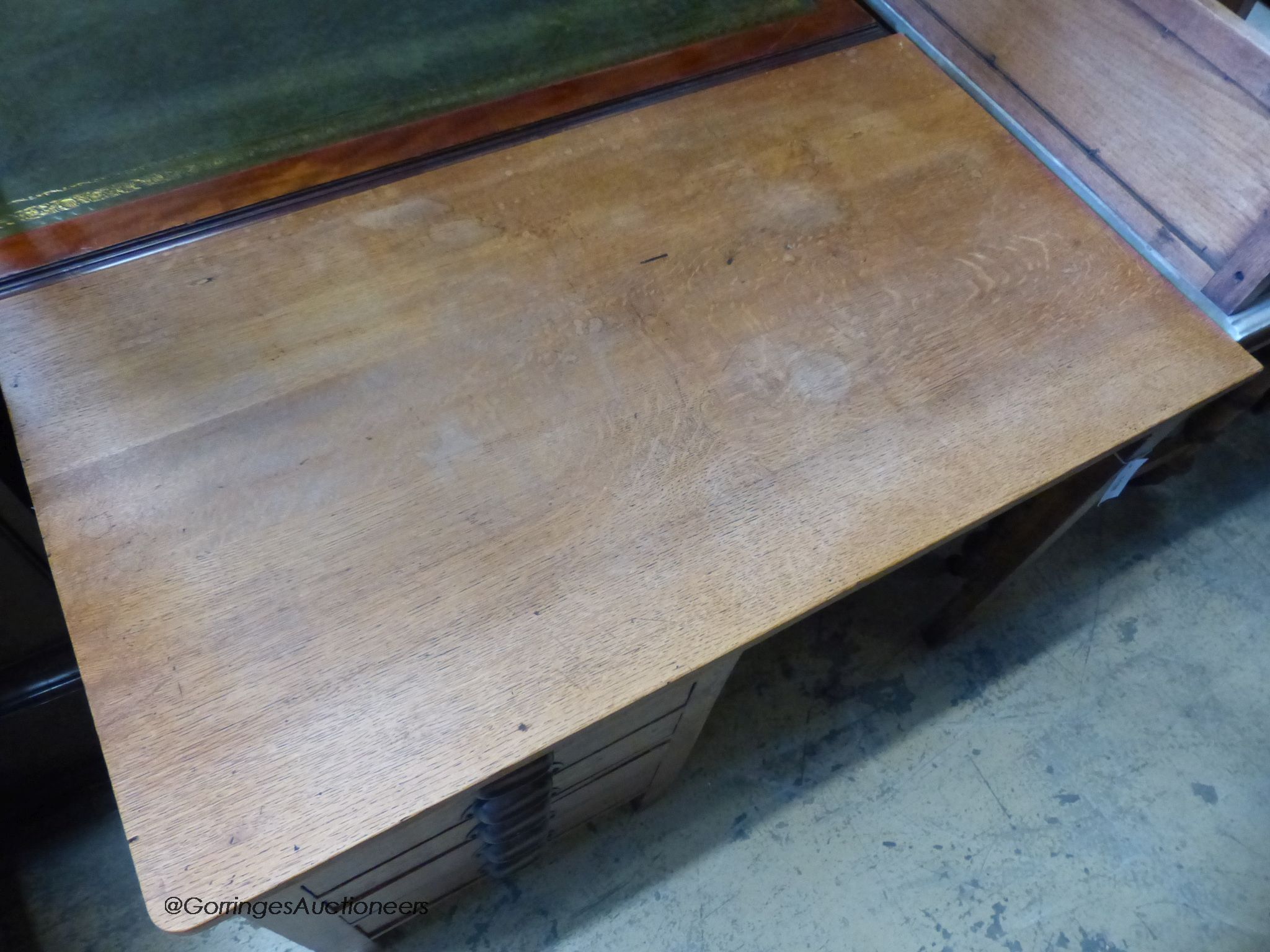 A 1940's oak kneehole desk, stamped G.R. W-107, D-59, H-73cm.